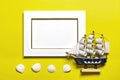 Palm and monstera leaves, orchid, seashells, white photo frame, ship on a yellow background.