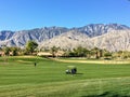 People out golfing at a beautiful golf course surrounded by mountains in the golf mecca of Palm Springs, California, United States