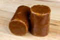 Palm Sugar or Gula Melaka on a Wooden Surface Royalty Free Stock Photo