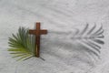 Palm sunday background. Cross and palm on grey background. Royalty Free Stock Photo