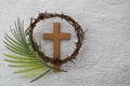 Palm sunday background. Cross and palm on grey background. Royalty Free Stock Photo