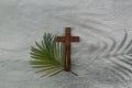 Palm sunday background. Cross and palm on grey background. Royalty Free Stock Photo