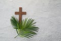 Palm sunday background. Cross and palm on grey background. Royalty Free Stock Photo