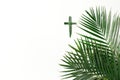 Palm Sunday concept. Cross made of palm and tropical leaves isolated on white background. Christian moveable feast to