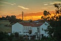 Palm tree and cottage at sunset on a farmstead Royalty Free Stock Photo