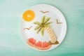 A palm tree and a sun of fruit, a creative of food on a white plate. Food Concept Royalty Free Stock Photo