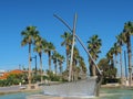 Palm trees and blue sky fountain in shape of  boat Royalty Free Stock Photo