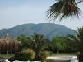 Palm trees and bungalows on the background of mountains Royalty Free Stock Photo