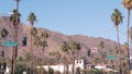 Palm trees in city near Los Angeles, street road sign, semaphore traffic lights.