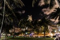 Palm trees and glowing buildings of South beach in Miami captured against the night sky Royalty Free Stock Photo