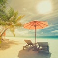 Tropical beach in vintage style effect. Sun umbrella and deck chairs, sun beds and palm trees under sunlight blue sea backgroud Royalty Free Stock Photo