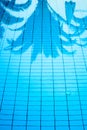 Palm trees reflected in the water surface of a swimming pool Royalty Free Stock Photo