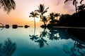 Palm Trees Silhouettes over blue infinity pool at sunset in Hawaii Royalty Free Stock Photo