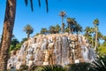 Palm trees, Waterfall and pond, Exotic island under a cloudless blue sky Royalty Free Stock Photo