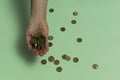 In the palm of a woman lies a handful of cash coins - the Israeli new shekel, agorot. Coins are still scattered under the palm.