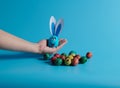 on the palm of your hand an egg with ears and Easter eggs Royalty Free Stock Photo