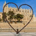 Palma cathedral with dachshund teckel dog posing for photograph inside large heart, palma, mallorca, spain