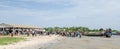 Palmarin, Senegal - October 30, 2013: Many people on beach with fish market and fishing boats, return of the fishermen