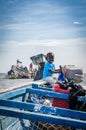 Palmarin, Senegal - October 30, 2013: Unidentified small African boy smiling and steering wooden fishing boat