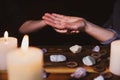 Palmistry or palm reading, fortuneteller holding a hand, healing stones and candles Royalty Free Stock Photo