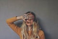 Palmistry themed portrait of young blond female wiccan witch placing her painted hand on her face and eyes Royalty Free Stock Photo
