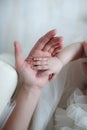 Small hands of a newborn baby in the tender palms of a caring mother Royalty Free Stock Photo