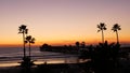 Palms and twilight sky in California USA. Tropical ocean beach sunset atmosphere. Los Angeles vibes. Royalty Free Stock Photo