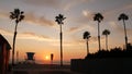 Palms and sunset sky, California aesthetic. Los Angeles vibes. Lifeguard watchtower, watch tower hut Royalty Free Stock Photo