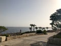 Palms and tropical green trees in nature and stone fencing, fence, railings and stairs on the mountainside in a sea tropical resor Royalty Free Stock Photo