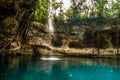 Palmtrees against blue sky with flags in a rowCenote Ek Balam