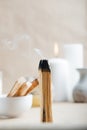 Palo Santo bar smokes close-up and copy space. Ritual cleansing with sacred ibiocai, meditation, aromatherapy with incense and