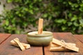 Palo Santo holy wood sticks and holder on wooden table outdoors