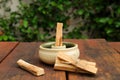 Palo Santo holy wood sticks and holder on wooden table outdoors