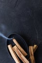 Palo Santo stick burning with aroma smoke for meditation and aroma ceremony. Mindfulness and slow living concept