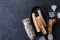 Palo Santo stick burning with aroma smoke, white sage, crystals for meditation esoteric ceremony. Mindfulness and slow living