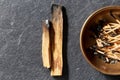 Palo santo sticks and cup with burnt matches