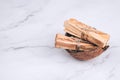 Palo Santo tree sticks inside coconut shell on marble background - holy incense tree from Latin America. Meditation