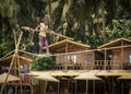 PALOLEM, GOA, INDIA - MARCH 19, 2019: A little tightrope walker girl walks tensely high above the ground