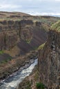 The Palouse river flowing at the base of ancient cliffs at Palouse Falls State Park, Washington, USA