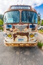 Front end of a rusted vintage Flxible brand bus