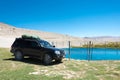 Toyota Land Cruiser are stoped on the Ak Balyk Lake in Gorno-Badakhshan, Tajikistan Royalty Free Stock Photo