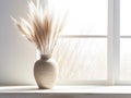 Pampas grass in decorative ceramic vase on table against blurred window and white wall with poster Royalty Free Stock Photo