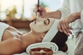 Pamper your gorgeous self. an attractive young woman getting a facial at a beauty spa.