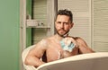 Pampering and beauty routine. Man handsome muscular guy relaxing in bath. Spa wellness concept. Taking bath with soap Royalty Free Stock Photo