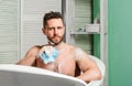 Pampering and beauty routine. Man handsome muscular guy relaxing in bath. Spa wellness concept. Taking bath with soap Royalty Free Stock Photo
