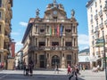 town hall of Pamplona, Spain, with local flags in sunshine