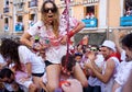 PAMPLONA, SPAIN - JULY 6: A woman watering red wine at opening o