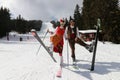 People dressed with traditional Bulgarian clothes skiing with the Bulgarian national flag. Royalty Free Stock Photo