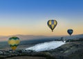 Pamukkale, Denizli, Turkiye - July 7, 2022 : Top view, balloon tourism activities in the sky floating above Cotton Castle or white