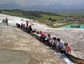 Pamukkale, Turkey - April 26, 2015: Tourists feet immersed in water flows coming from the travertine terraces